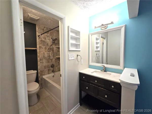 a bathroom with a bathtub sink mirror and toilet