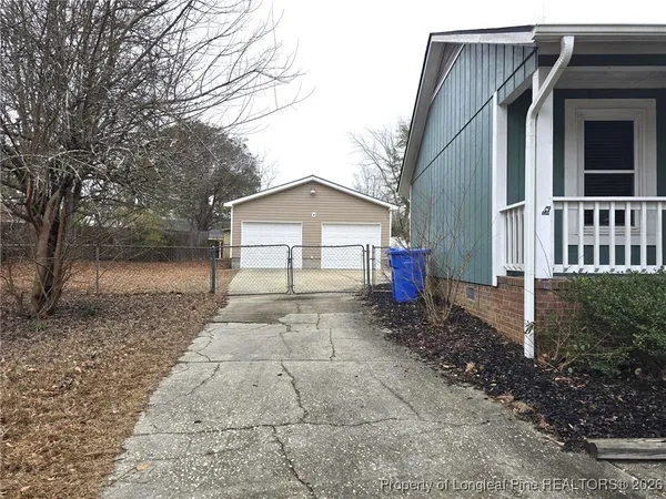 a view of house with wooden fence