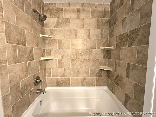 a bathroom with a toilet sink double vanity and mirror