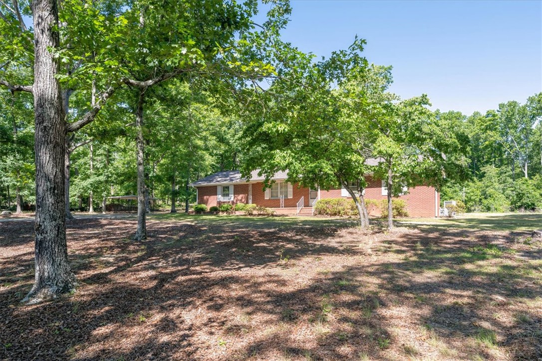 304 Shaw Road Honea Path, SC 29654 - Photo 1 of 39 This classic brick residence is nestled amongst mature trees, offering a private and serene setting.