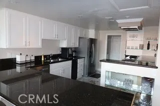 a kitchen with a sink a stove and refrigerator