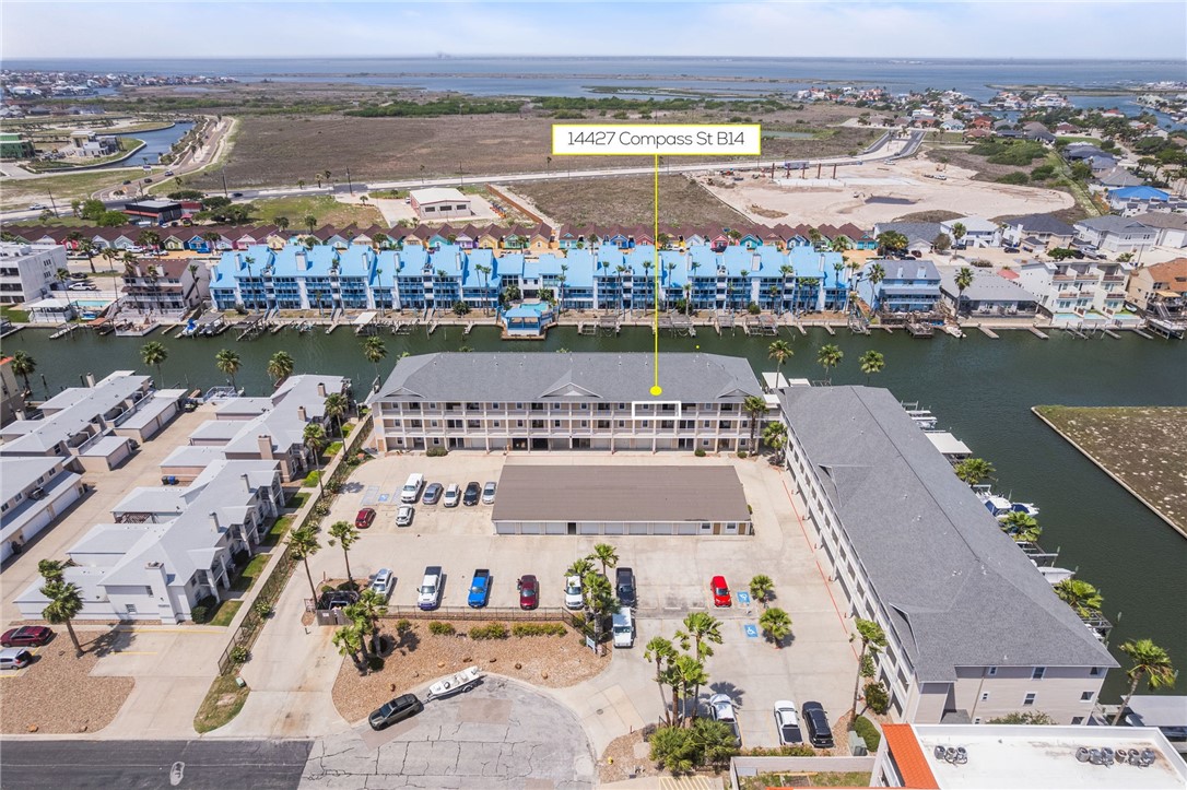 14427 Compass Street, Unit B14 Corpus Christi, TX 78418 - Photo 1 of 25 an aerial view of a houses with outdoor space and ocean view