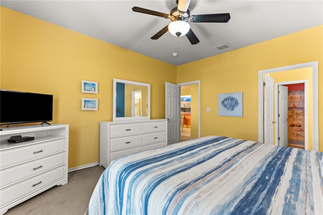 14427 Compass Street, Unit B14 Corpus Christi, TX 78418 - Photo 11 of 25 a bedroom with a bed and a flat screen tv