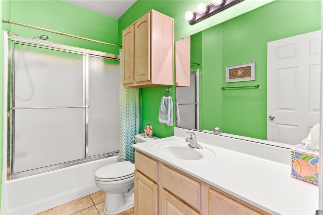 14427 Compass Street, Unit B14 Corpus Christi, TX 78418 - Photo 14 of 25 a bathroom with a sink a toilet and a shower