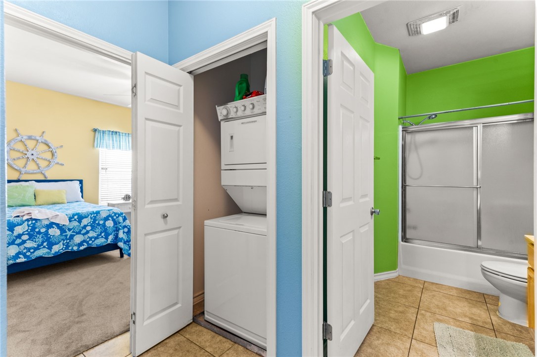 14427 Compass Street, Unit B14 Corpus Christi, TX 78418 - Photo 15 of 25 a bedroom with a bed and a view of bathroom