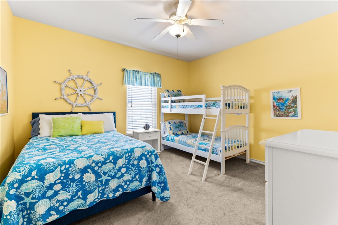 14427 Compass Street, Unit B14 Corpus Christi, TX 78418 - Photo 16 of 25 a bedroom with a bed and a chandelier