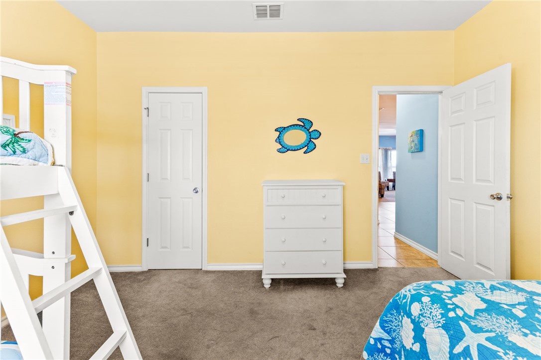 14427 Compass Street, Unit B14 Corpus Christi, TX 78418 - Photo 17 of 25 a bedroom with a bed and a cabinets