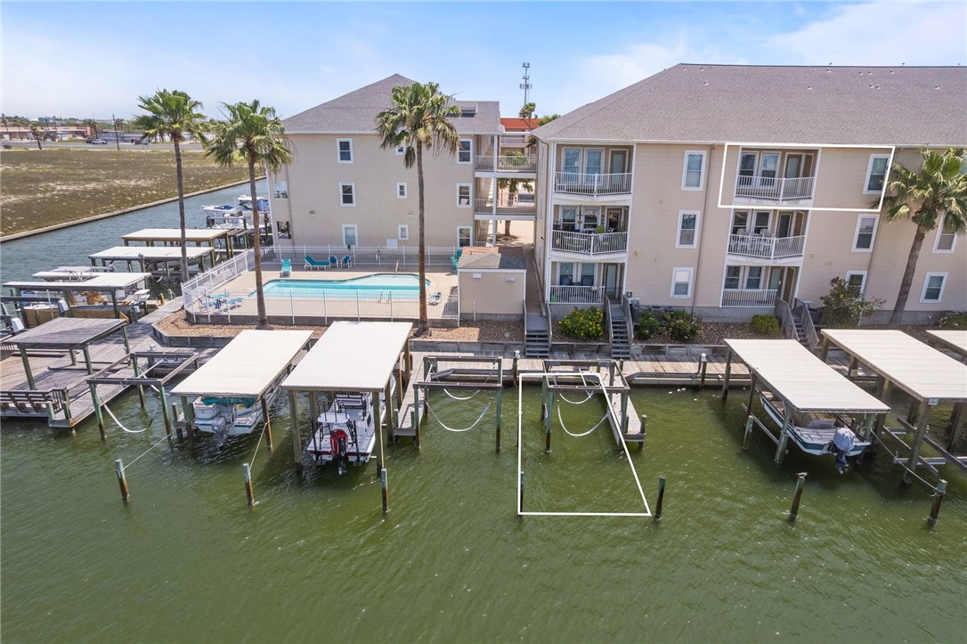14427 Compass Street, Unit B14 Corpus Christi, TX 78418 - Photo 2 of 25 a swimming pool with outdoor seating and yard