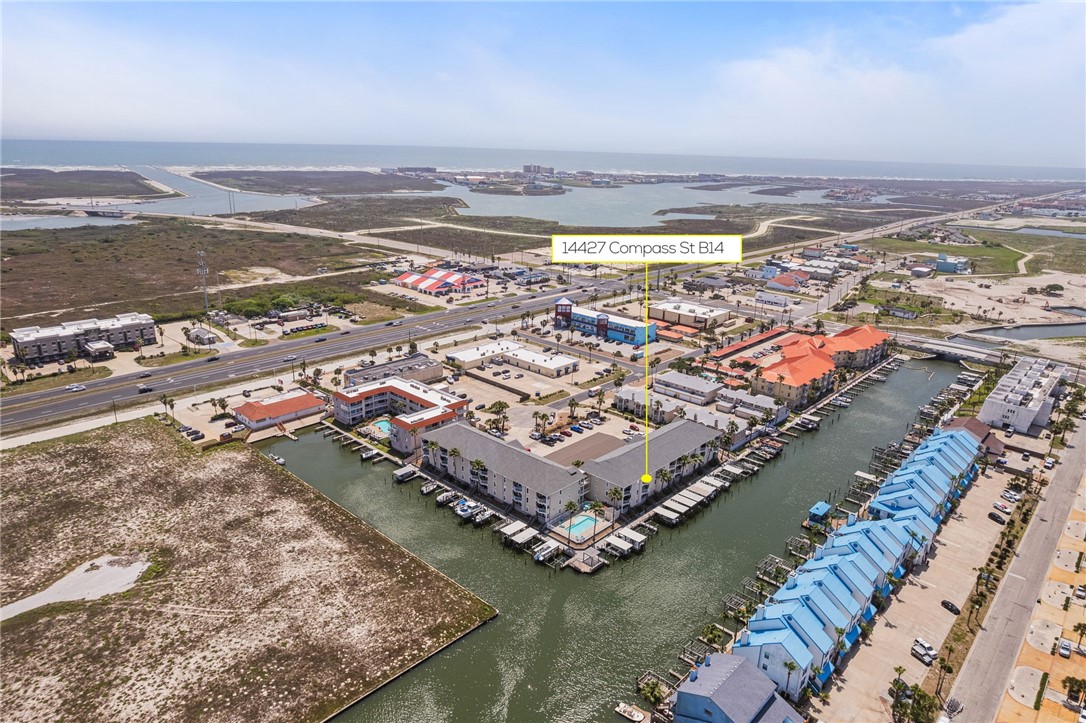 14427 Compass Street, Unit B14 Corpus Christi, TX 78418 - Photo 23 of 25 an aerial view of ocean and residential houses with outdoor space