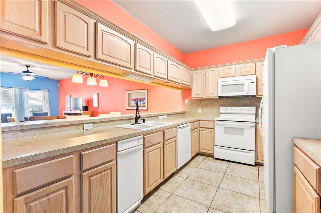 14427 Compass Street, Unit B14 Corpus Christi, TX 78418 - Photo 6 of 25 a kitchen with appliances cabinets and a sink