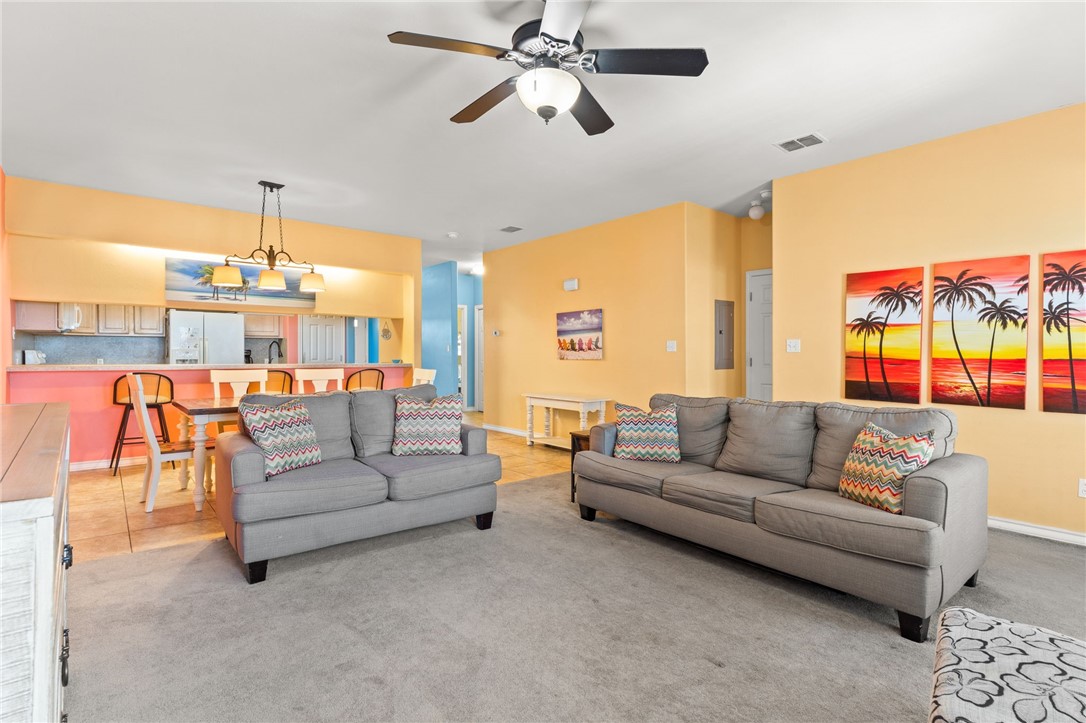 14427 Compass Street, Unit B14 Corpus Christi, TX 78418 - Photo 9 of 25 a living room with furniture and a chandelier