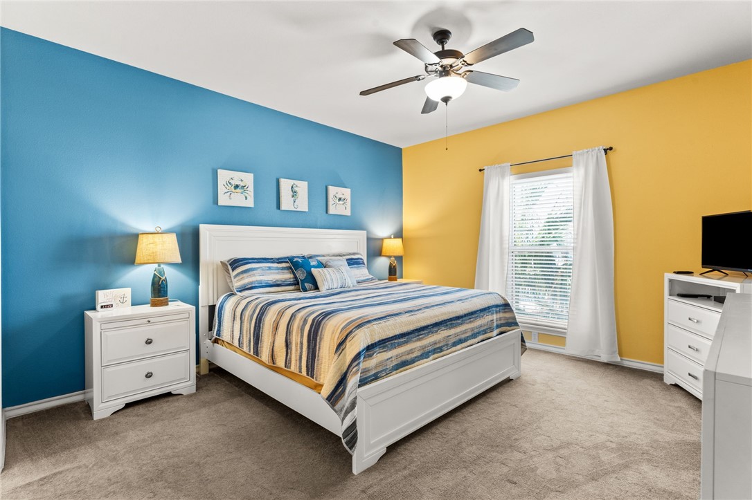 14427 Compass Street, Unit B14 Corpus Christi, TX 78418 - Photo 10 of 25 a spacious bedroom with a bed and a table