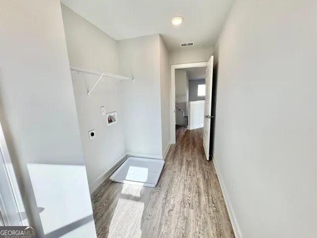 a view of hallway with wooden floor