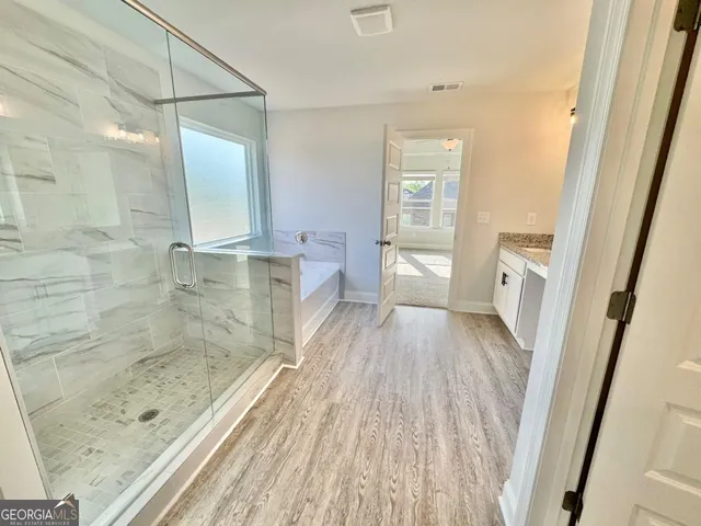 a bathroom with a sink and shower