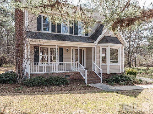 9312 Tallgrass Road Raleigh, NC 27603 - Photo 1 of 18 a front view of a house with a yard and potted plants
