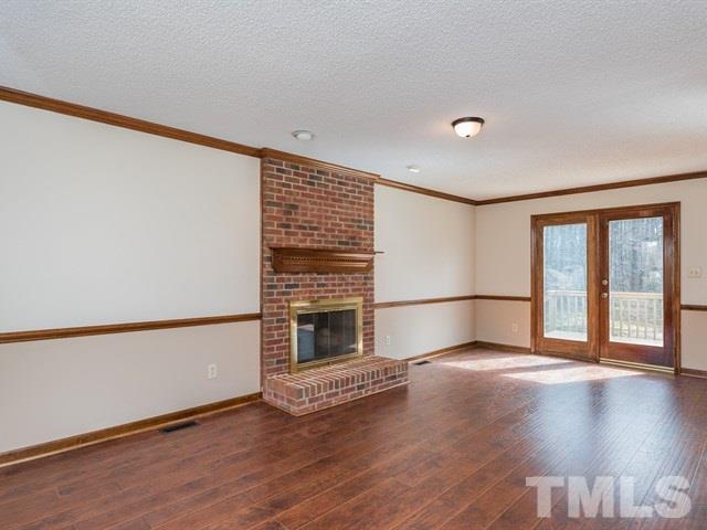 9312 Tallgrass Road Raleigh, NC 27603 - Photo 11 of 18 a view of an empty room with wooden floor and a window