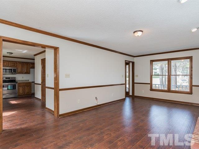 9312 Tallgrass Road Raleigh, NC 27603 - Photo 12 of 18 a view of a livingroom with wooden floor