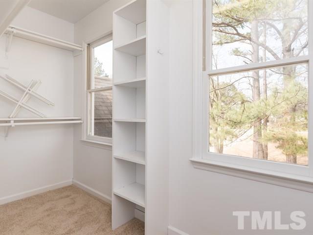 9312 Tallgrass Road Raleigh, NC 27603 - Photo 15 of 18 a view of an empty room with a window and wooden floor