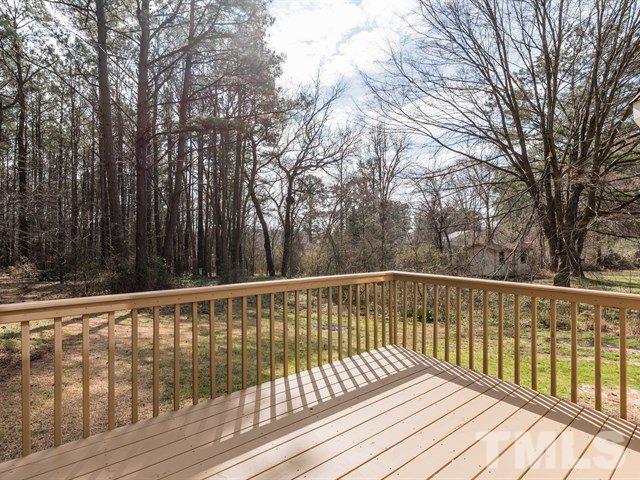 9312 Tallgrass Road Raleigh, NC 27603 - Photo 4 of 18 a view of wooden deck and trees with wooden fence