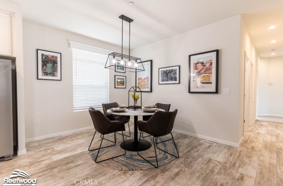 22678 La More Road Perris, CA 92570 - Photo 9 of 15 a view of a dining room with furniture a chandelier and wooden floor