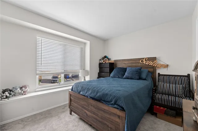 a bedroom with bed and window