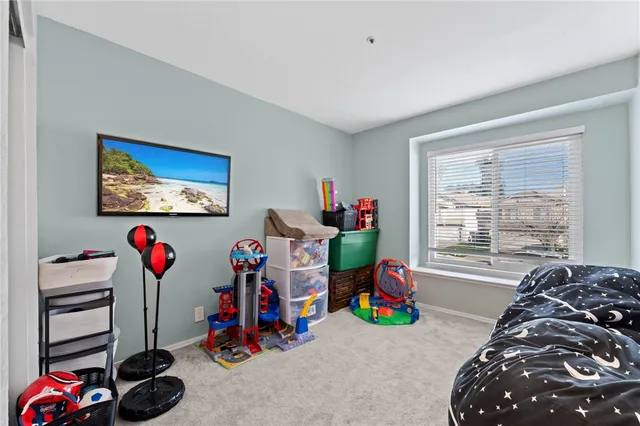a view of a room with toys and a flat screen tv