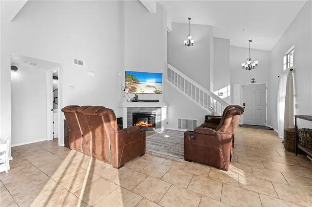 a living room with furniture a fireplace and a dining table