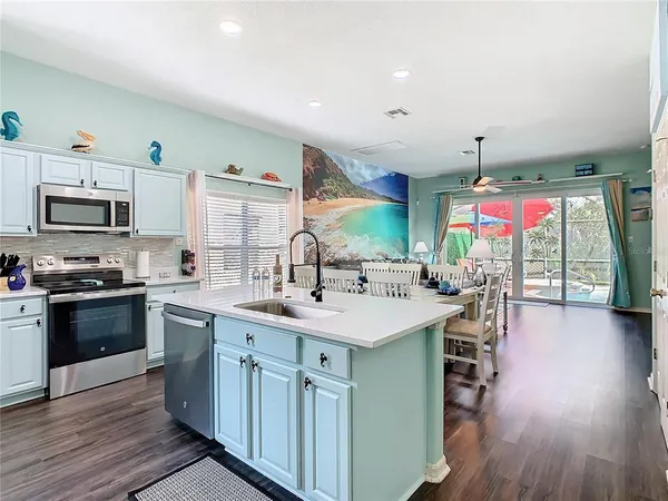 a kitchen with a sink stove and wooden cabinets
