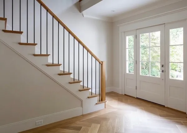 a view of entryway and hall with wooden floor