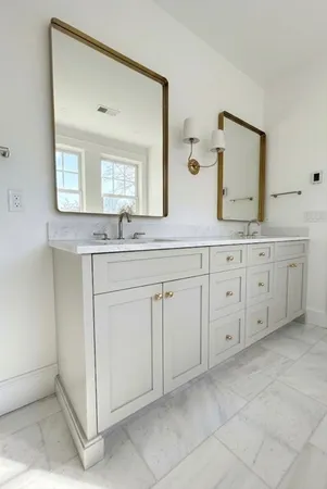 a spacious bathroom with a sink and a mirror