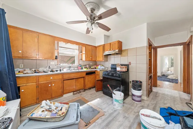 a kitchen with a sink stove and refrigerator