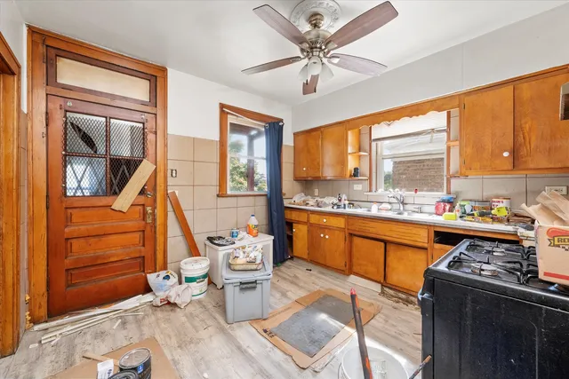 a open kitchen with stainless steel appliances granite countertop a stove top oven a sink and cabinets