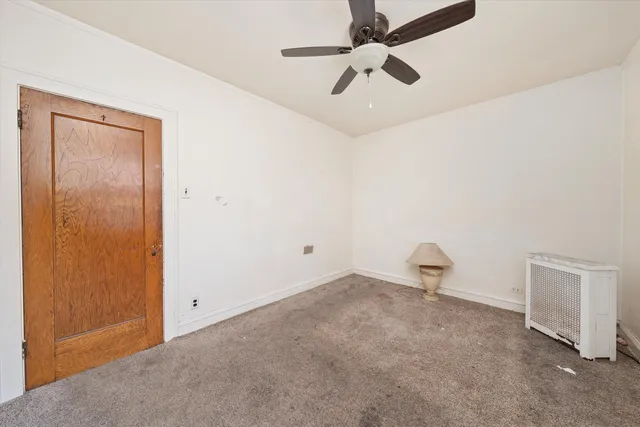 a view of a room with a ceiling fan and a window