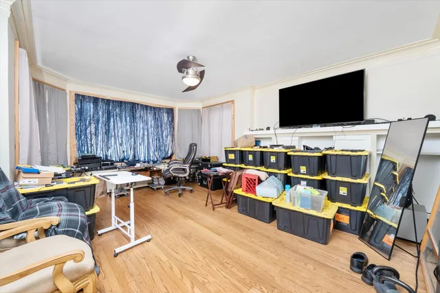 a view of a workspace with furniture and a flat screen tv