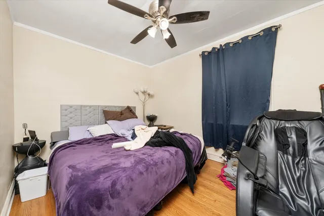 a bed room with a bed and a ceiling fan