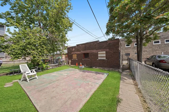 a front view of a house with a yard and trees
