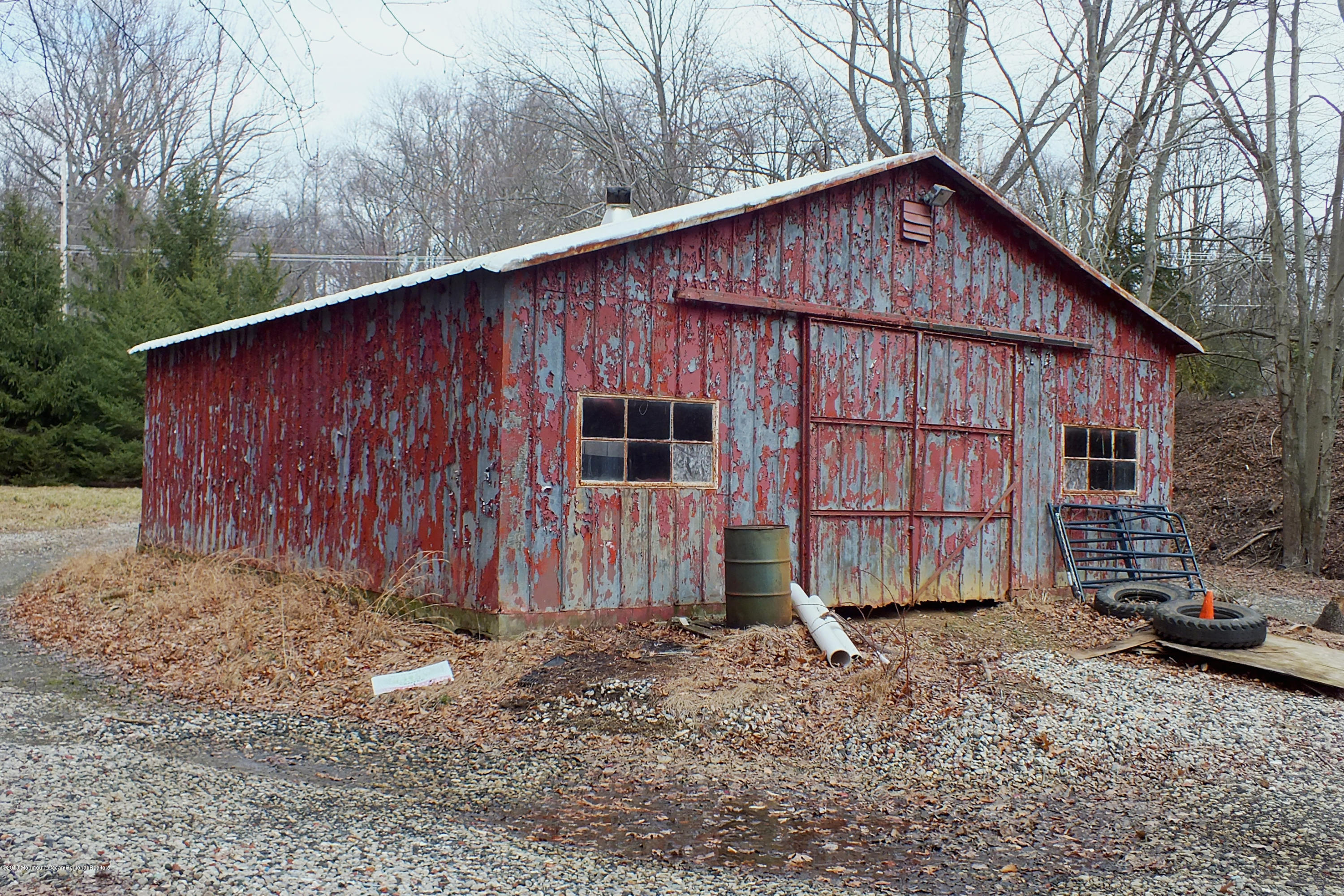 127 Crawfords Corner Road Holmdel, NJ 07733 - Photo 4 of 12 a view of a small barn with a large window and wooden fence