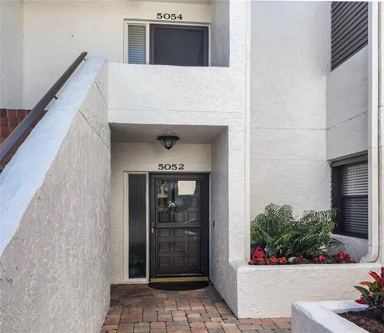 a potted plant sitting in front of a door
