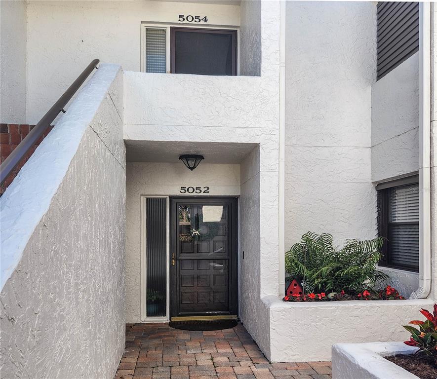 5052 Marsh Field Road, Unit 9 Sarasota, FL 34235 - Photo 1 of 15 a potted plant sitting in front of a door