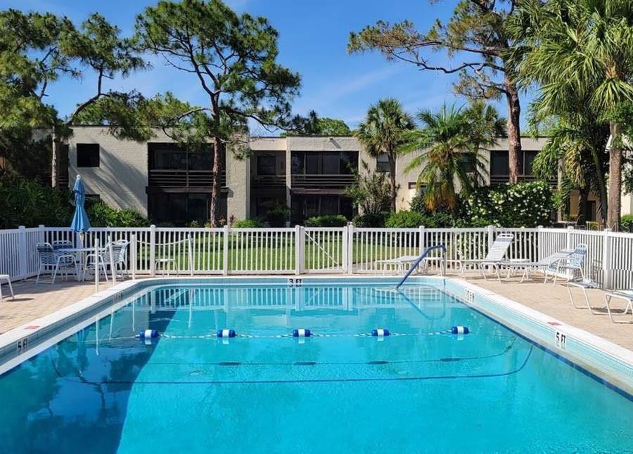 5052 Marsh Field Road, Unit 9 Sarasota, FL 34235 - Photo 12 of 15 a view of a swimming pool with an outdoor seating