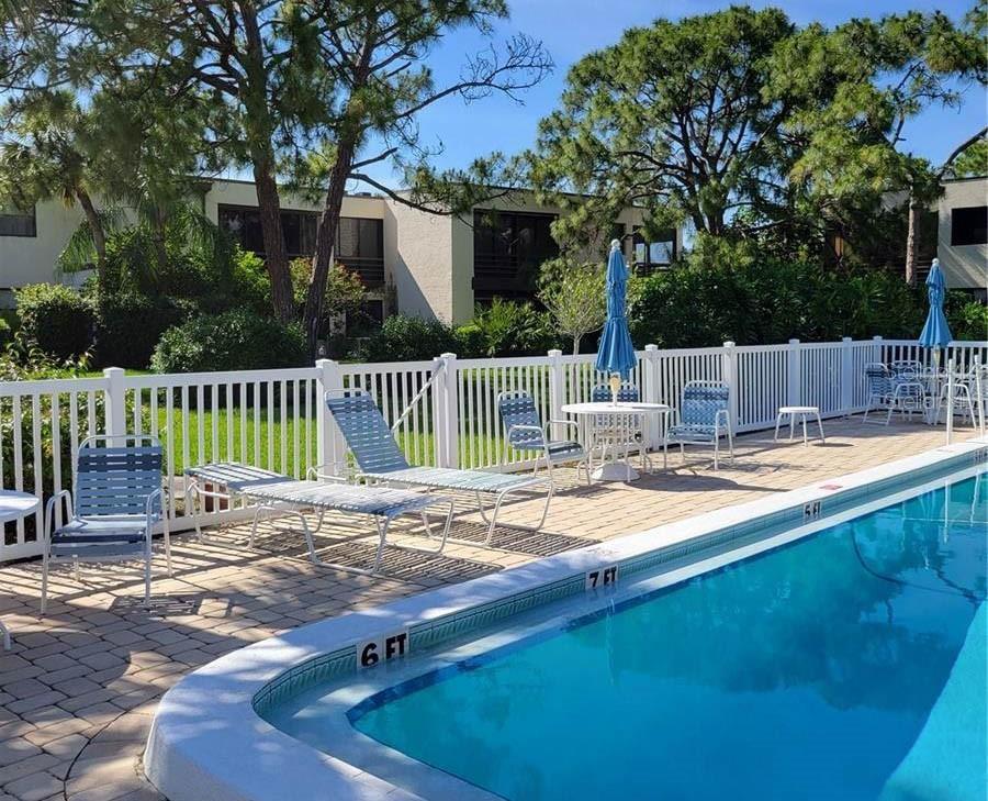 5052 Marsh Field Road, Unit 9 Sarasota, FL 34235 - Photo 14 of 15 a view of house with backyard and furniture