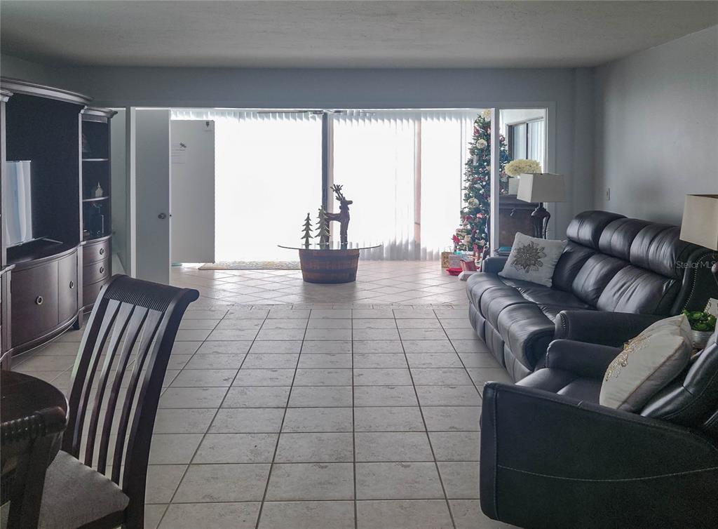 5052 Marsh Field Road, Unit 9 Sarasota, FL 34235 - Photo 2 of 15 a living room with furniture and a flat screen tv