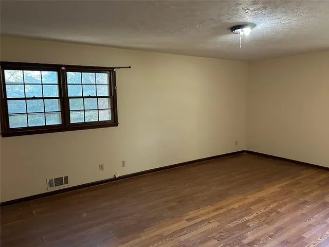 a white toilet sitting next to a bath tub and a shower