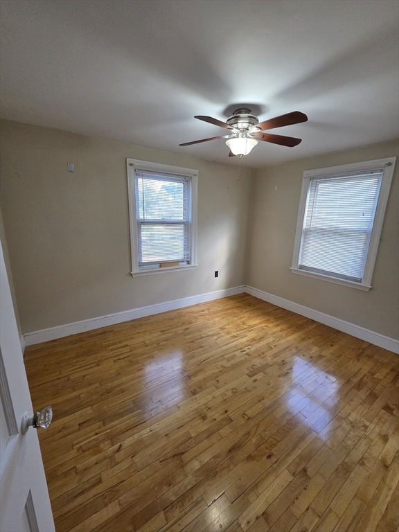 72 Barstow Street, Unit 1 Salem, MA 01970 - Photo 11 of 12 a view of empty room with wooden floor and fan