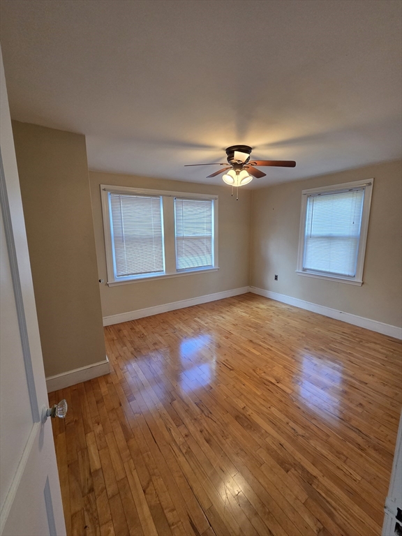 72 Barstow Street, Unit 1 Salem, MA 01970 - Photo 12 of 12 a view of an empty room with wooden floor and a window