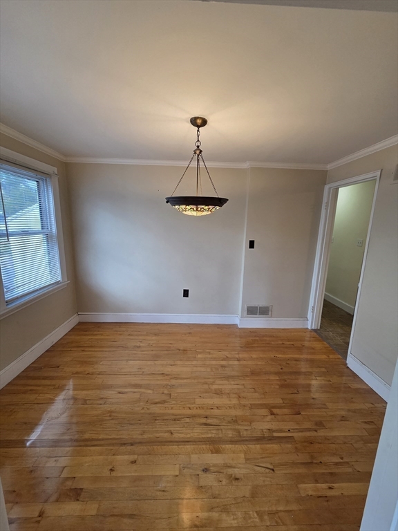 72 Barstow Street, Unit 1 Salem, MA 01970 - Photo 4 of 12 a view of an empty room with window and wooden floor