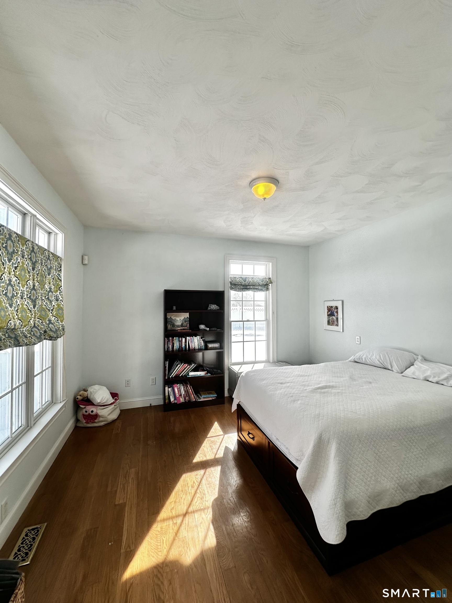 9 Leeward Lane Groton, CT 06340 - Photo 11 of 18 a bedroom with a bed and large windows