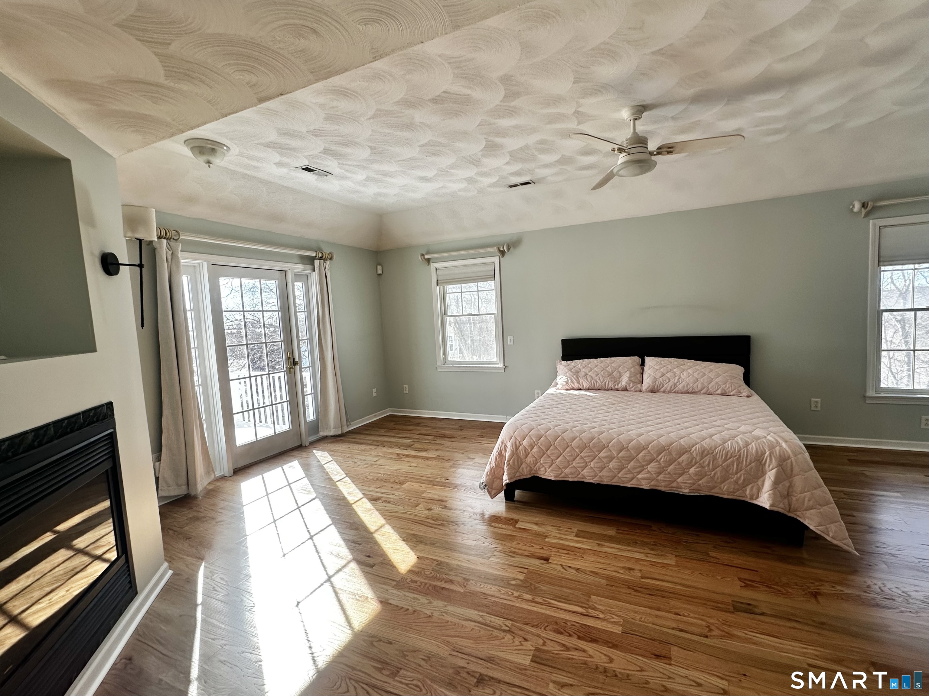 9 Leeward Lane Groton, CT 06340 - Photo 13 of 18 a bedroom with a bed and wooden floor