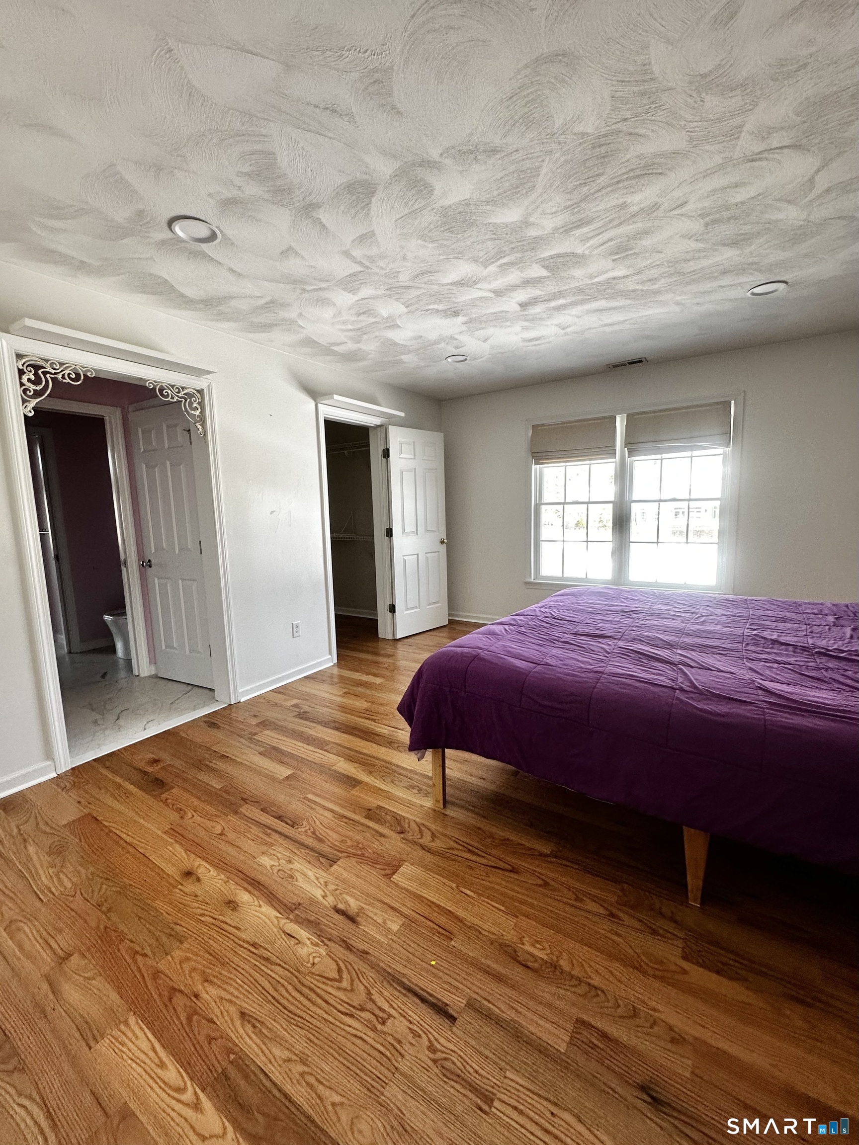 9 Leeward Lane Groton, CT 06340 - Photo 17 of 18 a spacious bedroom with a bed and a large mirror