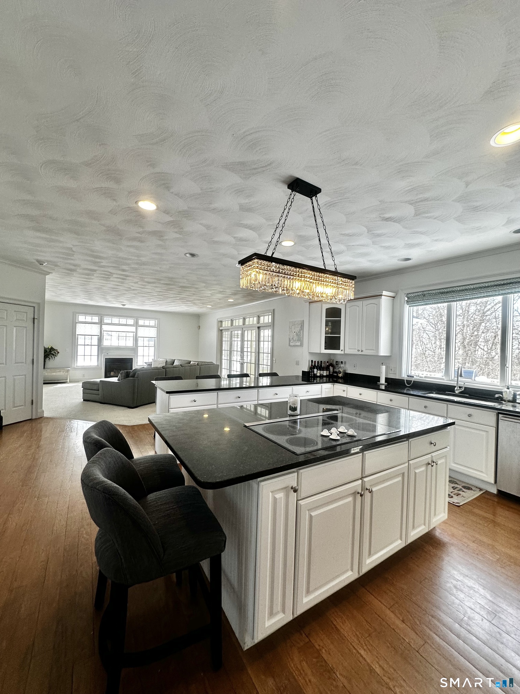 9 Leeward Lane Groton, CT 06340 - Photo 2 of 18 a kitchen with stainless steel appliances granite countertop a sink a stove and a wooden floors